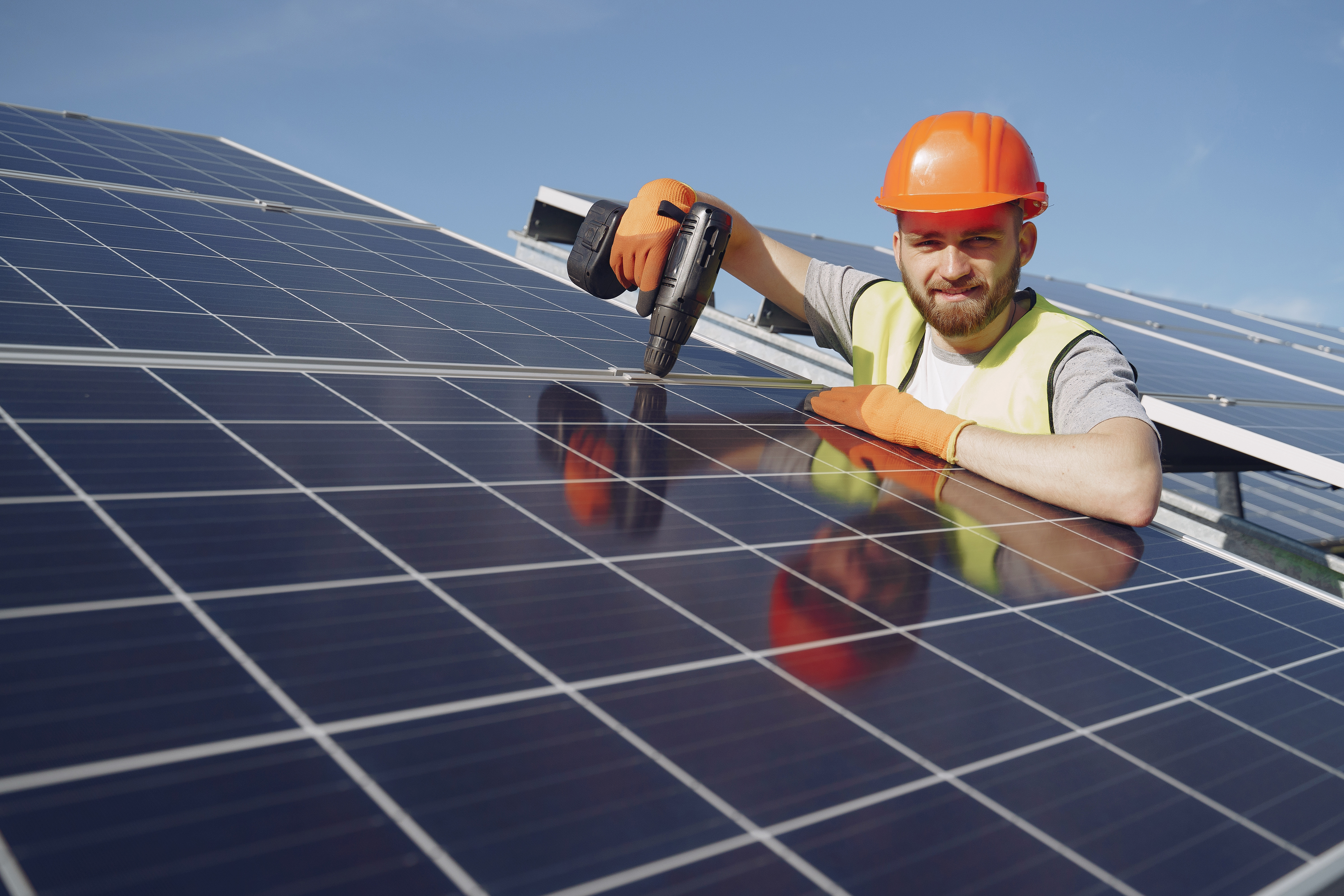 The EcoPlex team installing solar panels on a roof